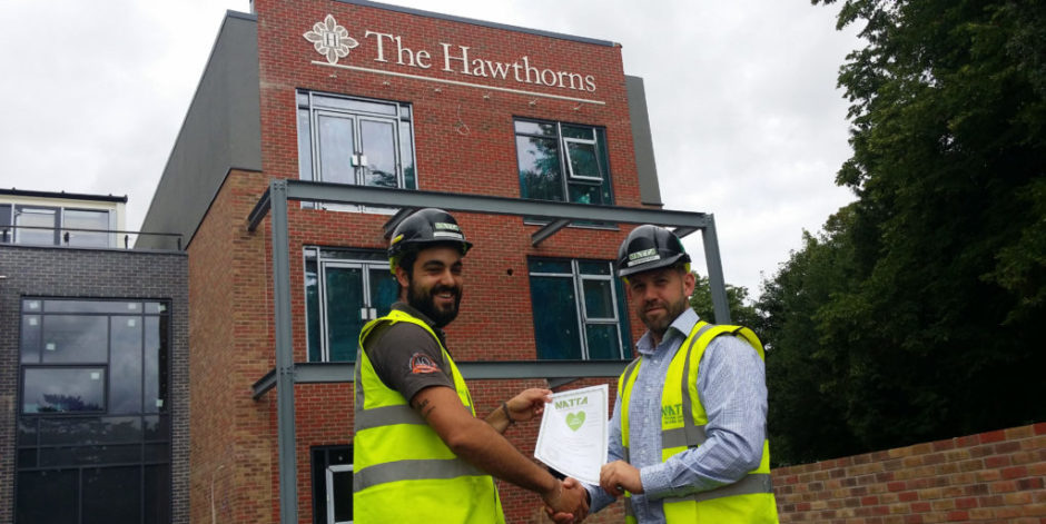At our care home project in Northampton. From left to right Alberto Gomez being presented with his award for Collaboration by Rob Winspear