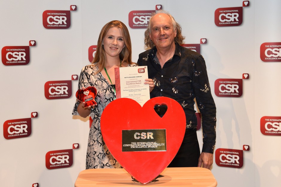 Iona Huckle receiving the CSR award on behalf of Natta from presenter Martin Kiszko