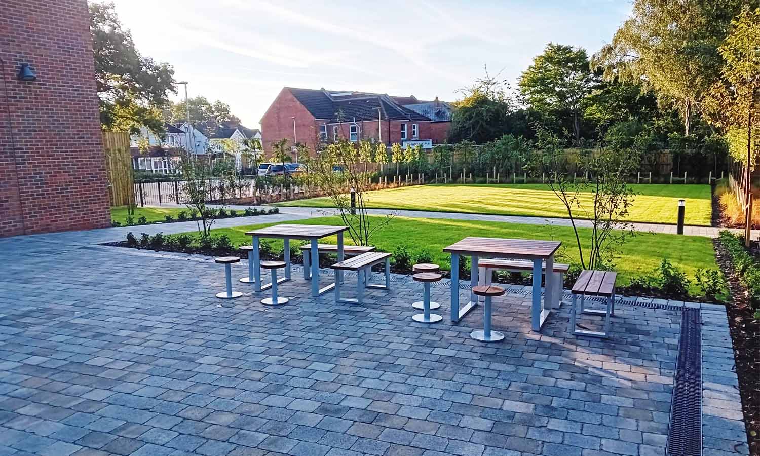 Modern landscaped outdoor seating area at the Sports Centre