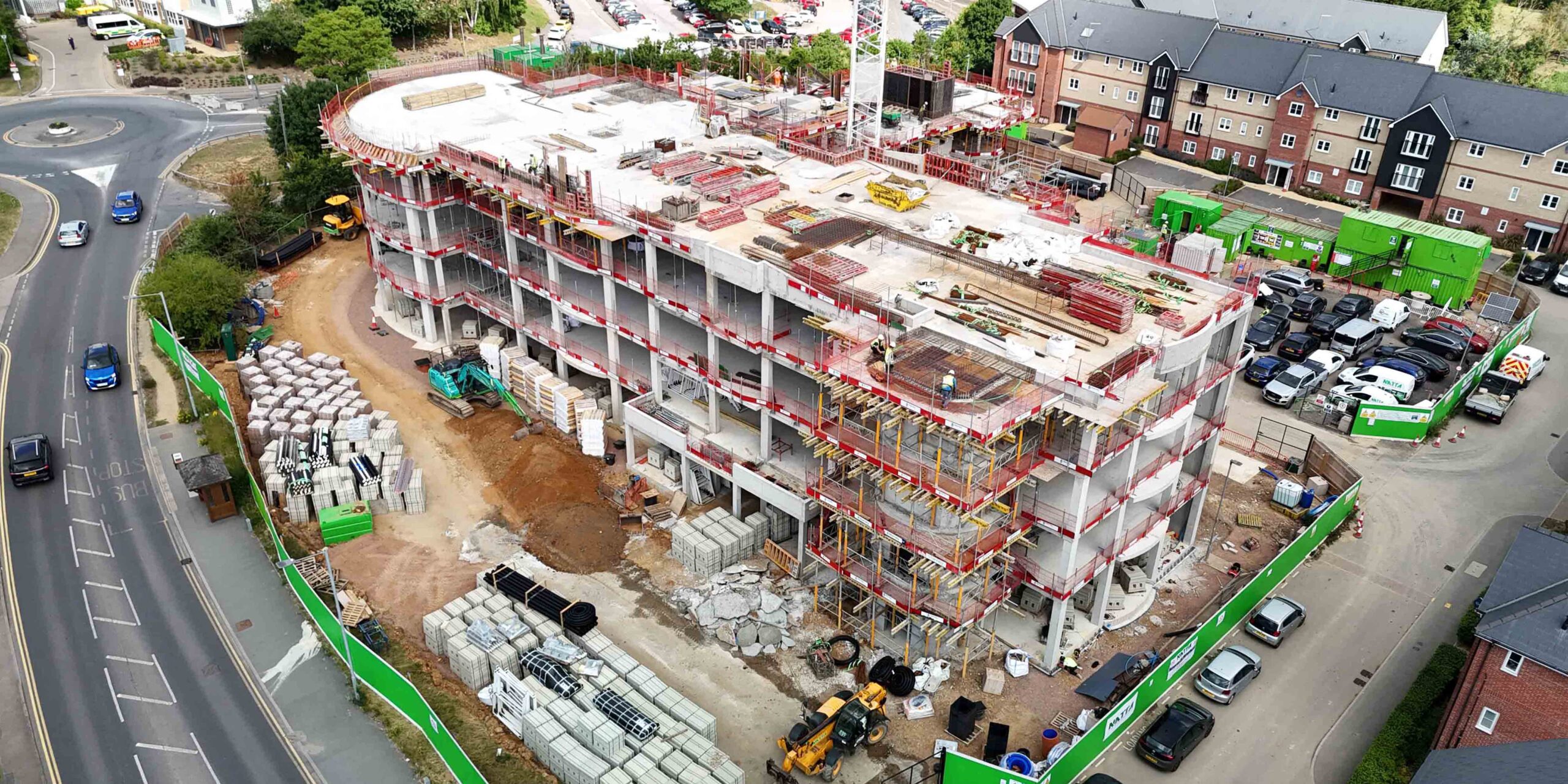 Front aerial view of a multi-storey care home under construction.