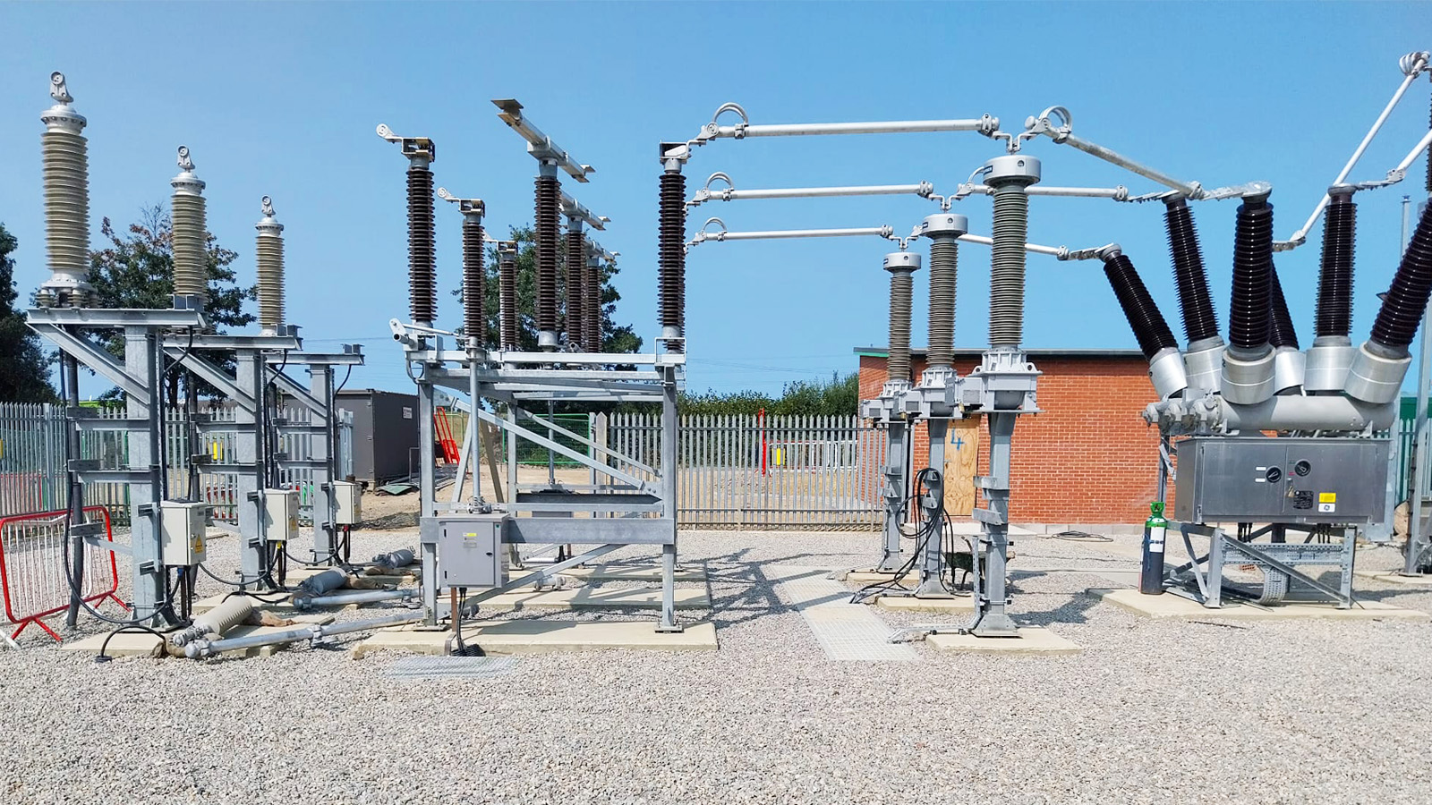 Solar PV Farm High voltage electrical equipment in a substation with insulators and circuit breakers.